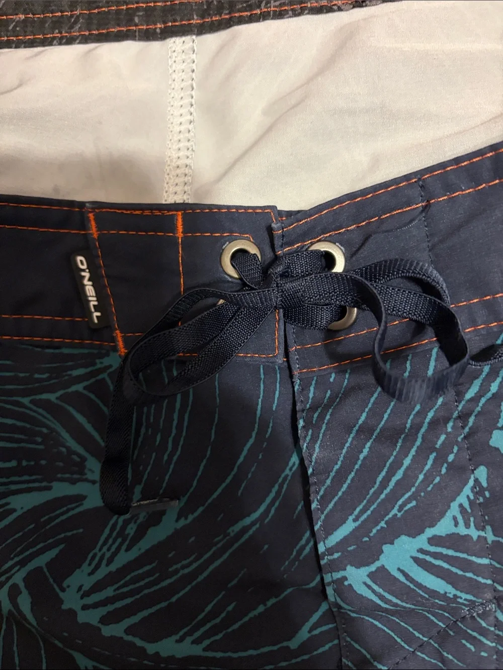 O'Neill Navy Swim Board Shorts with Teal Wave Print and Orange Accents